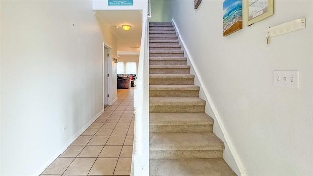 stairway featuring baseboards and tile patterned floors