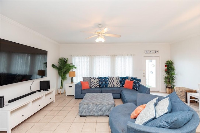 living area with ornamental molding, a ceiling fan, and light tile patterned flooring