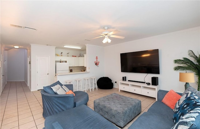 living area featuring ornamental molding, light tile patterned flooring, visible vents, and a ceiling fan