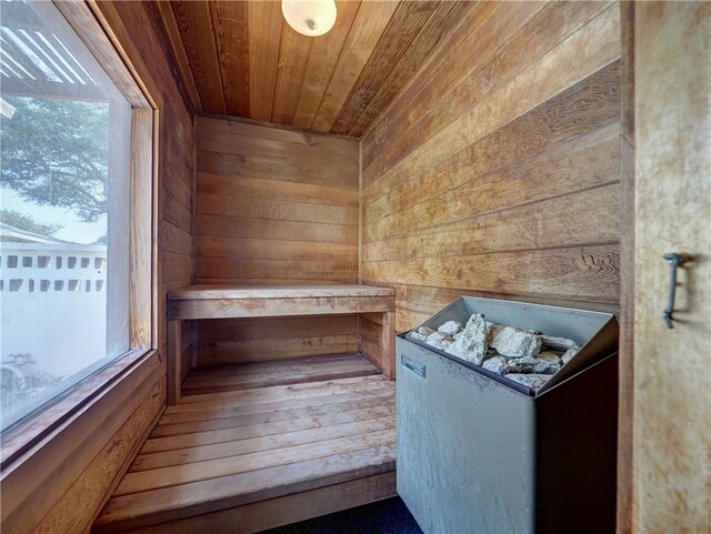 view of sauna featuring wooden walls and wood ceiling