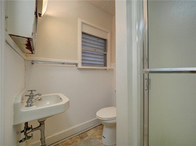 bathroom featuring an enclosed shower and toilet