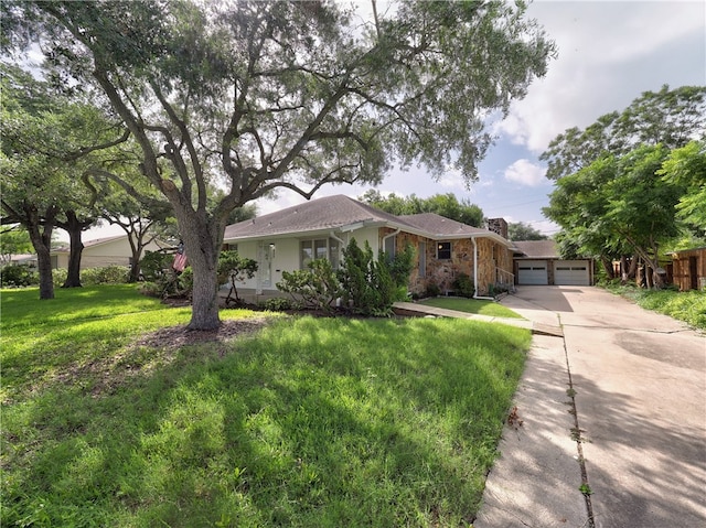 ranch-style house featuring a front lawn and a garage