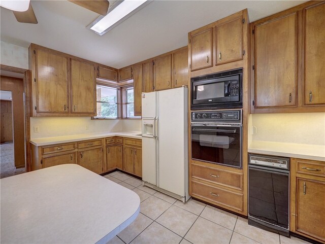 kitchen featuring black appliances, light tile patterned floors, and ceiling fan