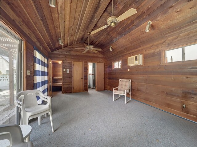 unfurnished room featuring wood walls, a wealth of natural light, and lofted ceiling