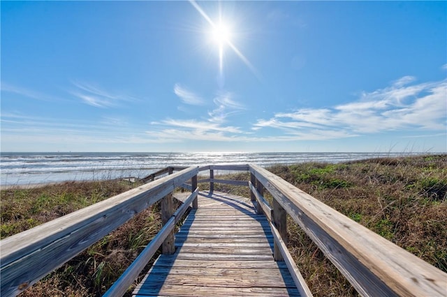 surrounding community featuring a beach view and a water view