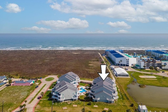 birds eye view of property featuring a water view and a view of the beach