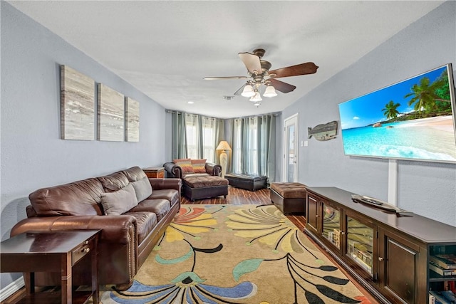 living room featuring ceiling fan and hardwood / wood-style floors