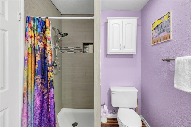 bathroom featuring toilet and a shower with shower curtain