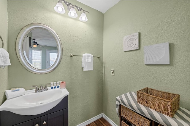 bathroom with ceiling fan, vanity, and hardwood / wood-style floors