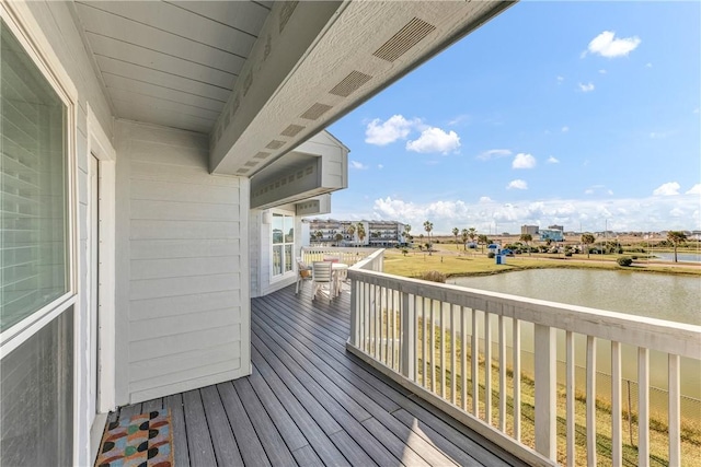 wooden deck with a water view