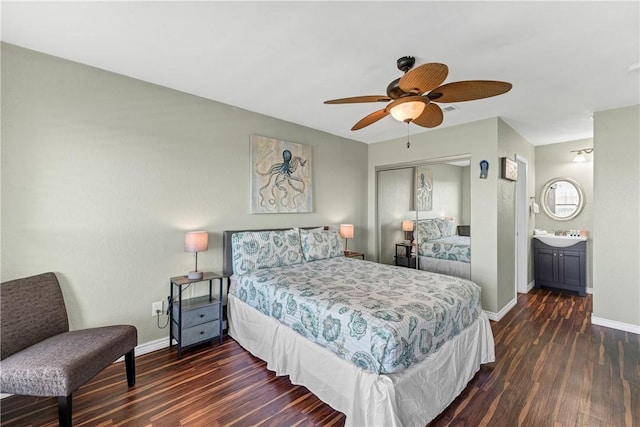 bedroom featuring ceiling fan, ensuite bathroom, and dark hardwood / wood-style flooring