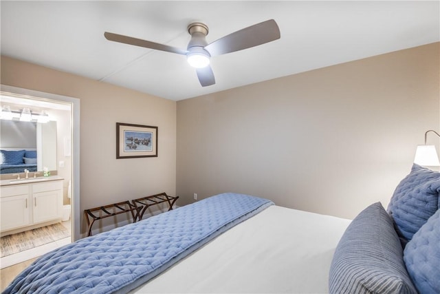 bedroom with sink, connected bathroom, ceiling fan, and light hardwood / wood-style floors