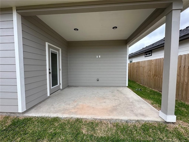 view of patio featuring fence