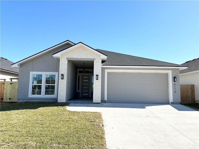 view of front of home with a garage, fence, a front lawn, and concrete driveway