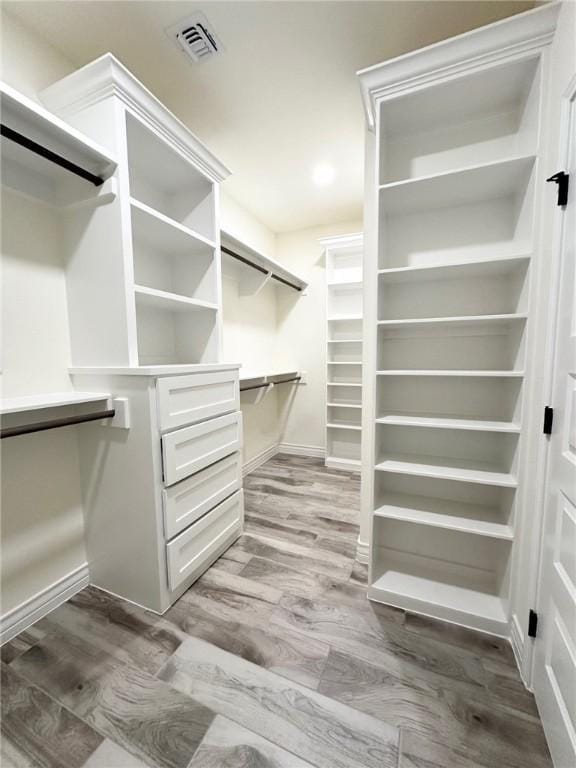 spacious closet with visible vents and wood finished floors