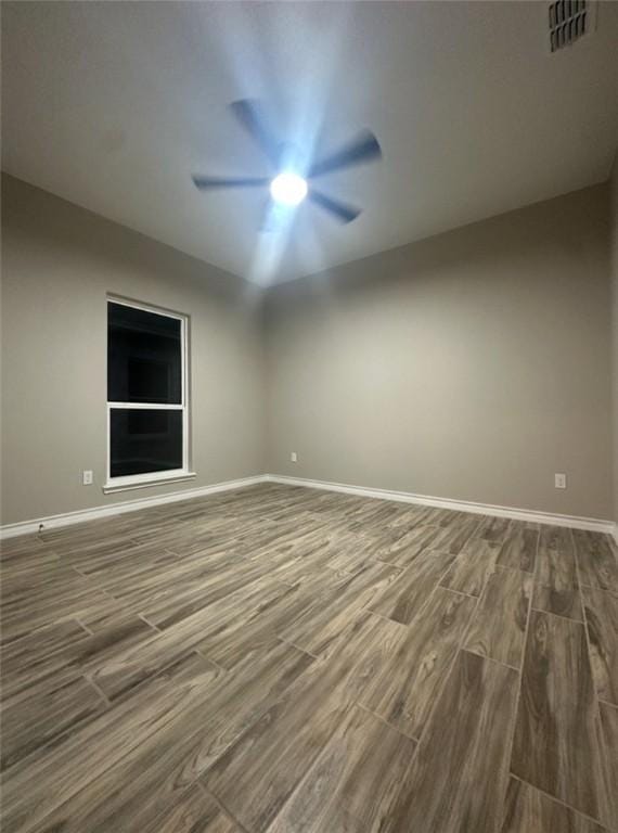 3141 Quail Springs Rd Unit 14, Corpus Christi, TX 78414 - empty room with dark wood-type flooring, baseboards, and a ceiling fan
