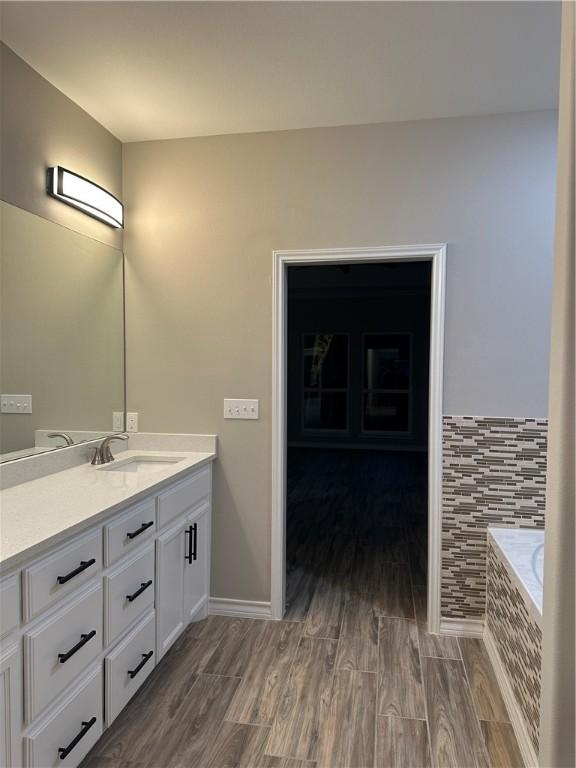 3141 Quail Springs Rd Unit 14, Corpus Christi, TX 78414 - full bathroom with vanity, wood finished floors, and tiled bath