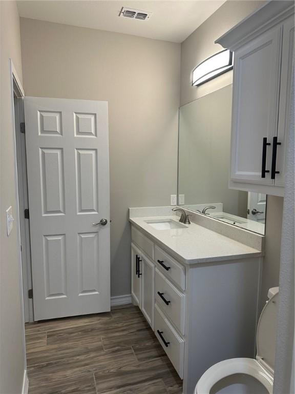 3141 Quail Springs Rd Unit 14, Corpus Christi, TX 78414 - half bath with vanity, toilet, baseboards, and wood finished floors