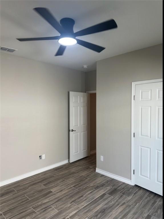 3141 Quail Springs Rd Unit 14, Corpus Christi, TX 78414 - unfurnished bedroom featuring wood finished floors, baseboards, and ceiling fan