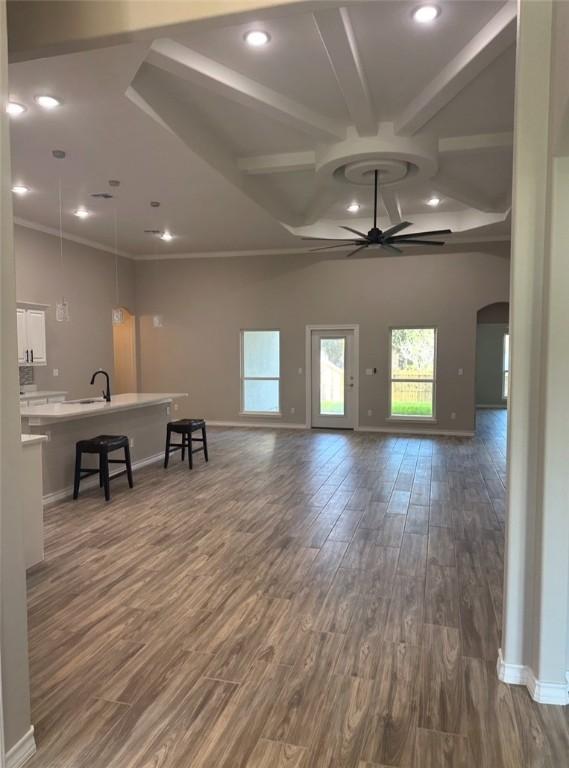 3141 Quail Springs Rd Unit 14, Corpus Christi, TX 78414 - living area with ceiling fan, wood finished floors, arched walkways, baseboards, and beam ceiling