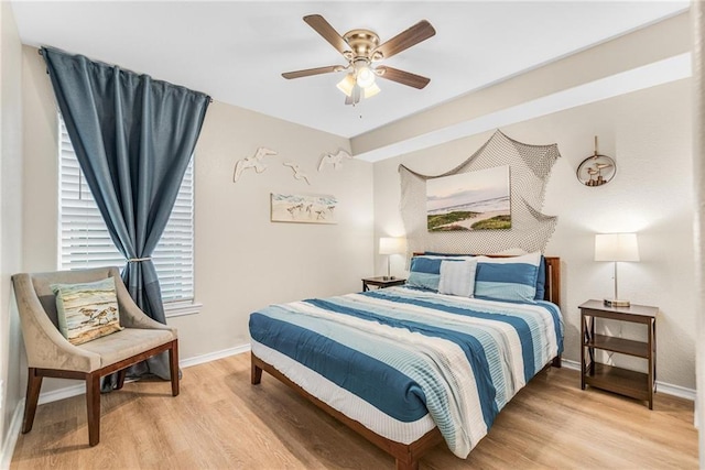 bedroom featuring light wood-type flooring, ceiling fan, and baseboards