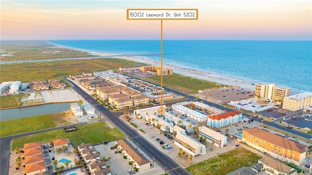 birds eye view of property featuring a view of the beach and a water view