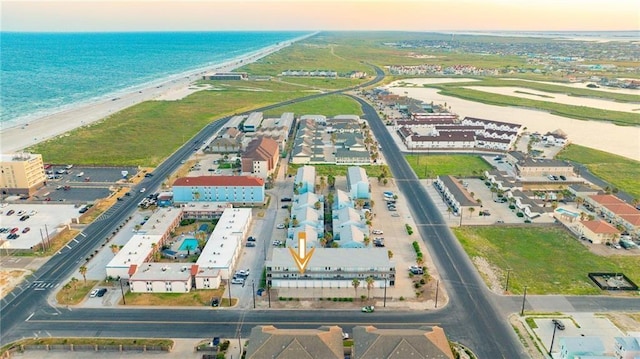 drone / aerial view featuring a water view and a view of the beach