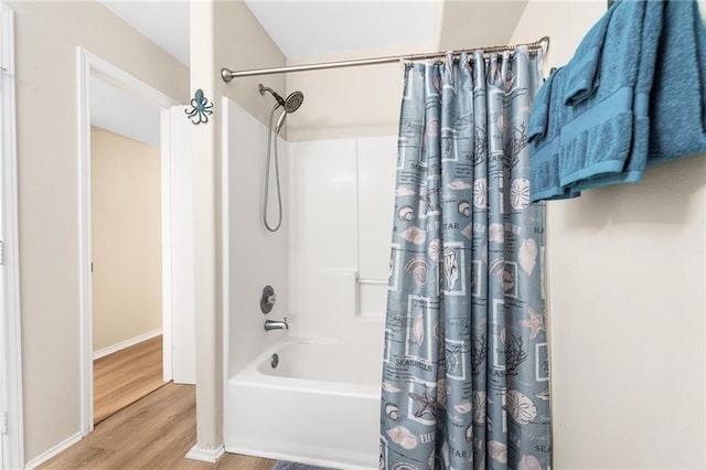 full bathroom featuring shower / tub combo with curtain and wood finished floors