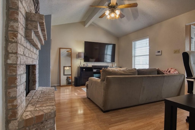2850 Tuscarora Dr, Corpus Christi, TX 78410 - living area with ceiling fan, a large fireplace, light wood-type flooring, and a textured ceiling