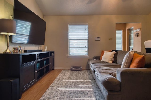 2850 Tuscarora Dr, Corpus Christi, TX 78410 - living room with light wood-style flooring, vaulted ceiling, and baseboards