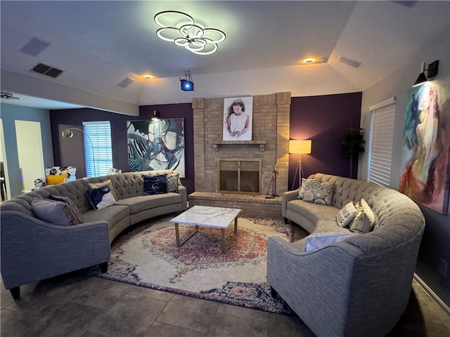 living room featuring a brick fireplace and vaulted ceiling