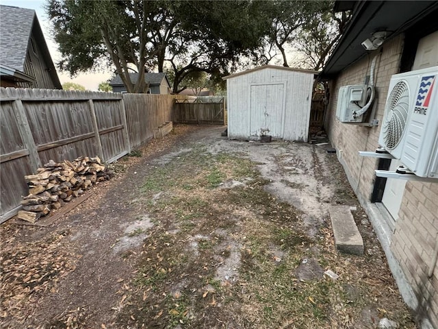 yard at dusk with ac unit and a storage unit