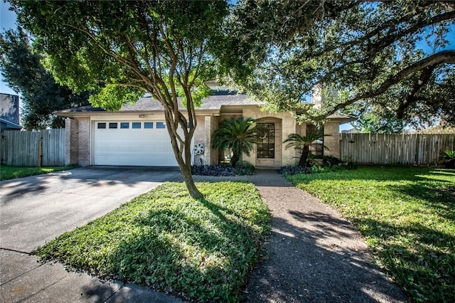 single story home featuring a garage and a front yard