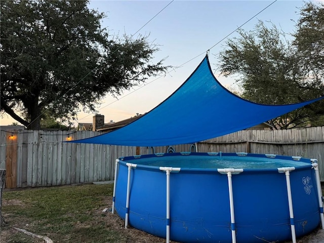 view of pool at dusk