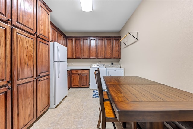 kitchen featuring white refrigerator and washing machine and clothes dryer