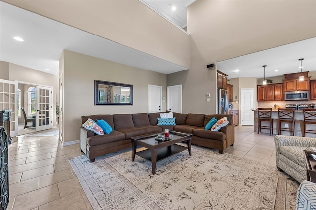 living room featuring light tile patterned floors and a towering ceiling