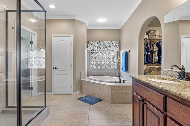 bathroom with tile patterned flooring, vanity, ornamental molding, and shower with separate bathtub