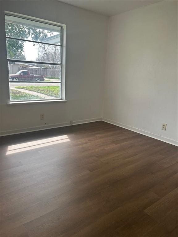 empty room featuring dark hardwood / wood-style flooring
