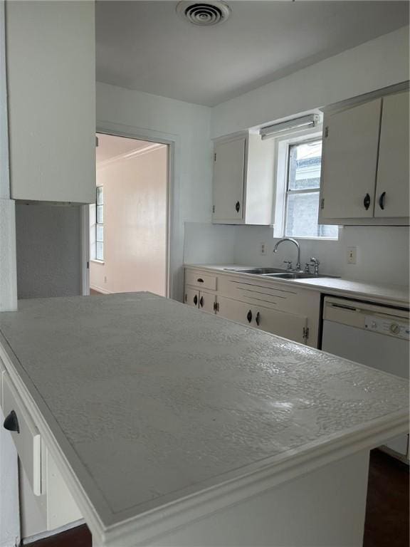 kitchen with white cabinetry and sink