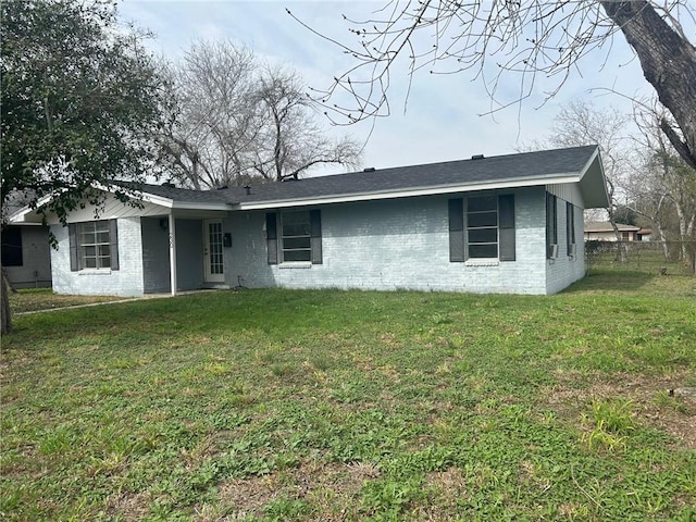 back of property featuring a lawn