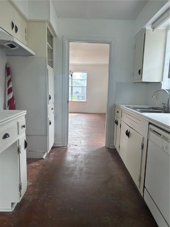 kitchen with white dishwasher, sink, and white cabinets