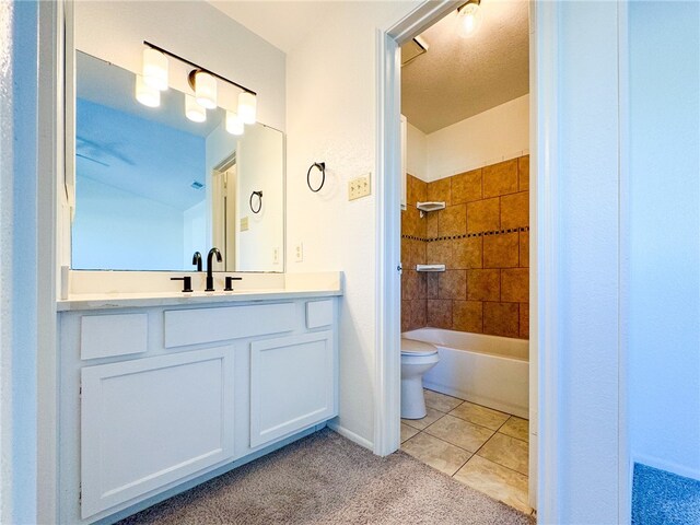 full bathroom with vanity, tile patterned flooring, toilet, and tiled shower / bath combo