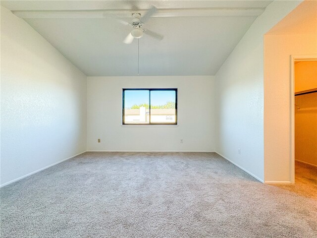 carpeted empty room featuring ceiling fan and lofted ceiling