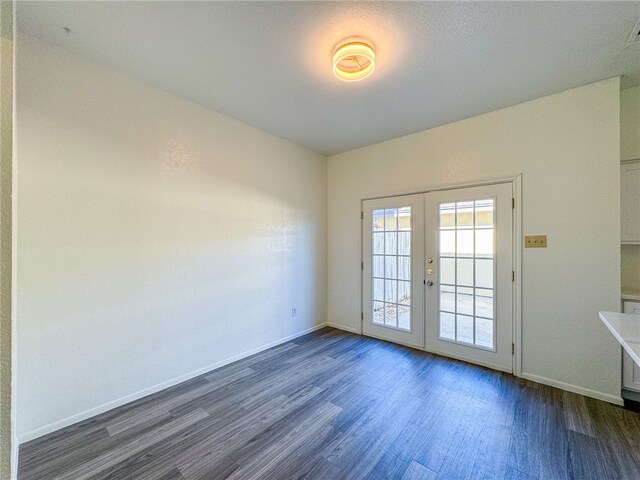 entryway featuring dark wood-type flooring and french doors