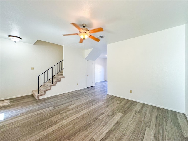 unfurnished living room with light wood-type flooring and ceiling fan