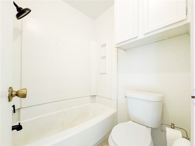 bathroom featuring toilet and  shower combination