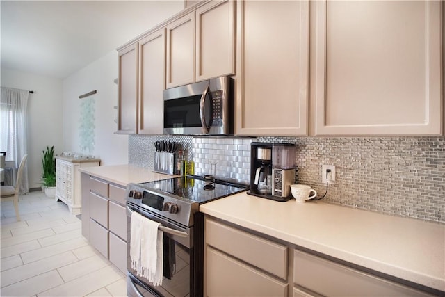 7002 Madiera Dr, Corpus Christi, TX 78414 - kitchen featuring appliances with stainless steel finishes, backsplash, light countertops, and light tile patterned flooring