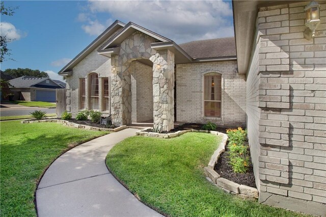 7002 Madiera Dr, Corpus Christi, TX 78414 - view of front facade featuring brick siding, a front yard, and roof with shingles