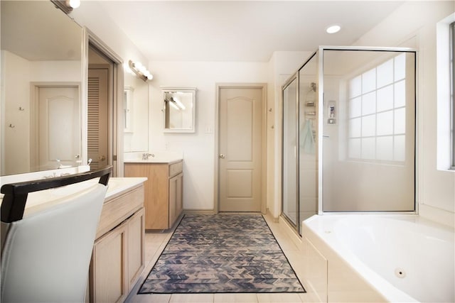7002 Madiera Dr, Corpus Christi, TX 78414 - bathroom featuring a stall shower, a whirlpool tub, two vanities, and recessed lighting