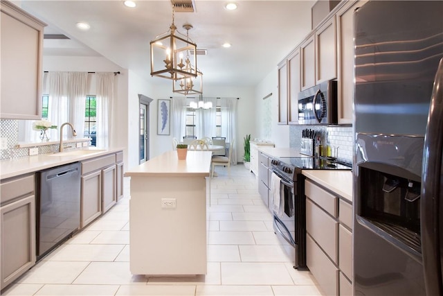7002 Madiera Dr, Corpus Christi, TX 78414 - kitchen featuring appliances with stainless steel finishes, a chandelier, a kitchen island, tasteful backsplash, and recessed lighting